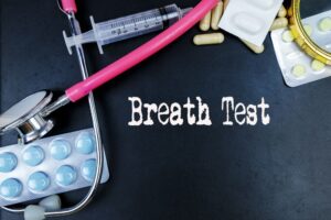 "Breath Test" - medical term with concepts illustrated on a blackboard alongside medical equipment. 